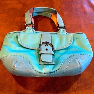 Aqua color coach bag. It is medium size. In good condition.